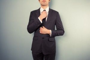 Young businessman adjusting his tie image